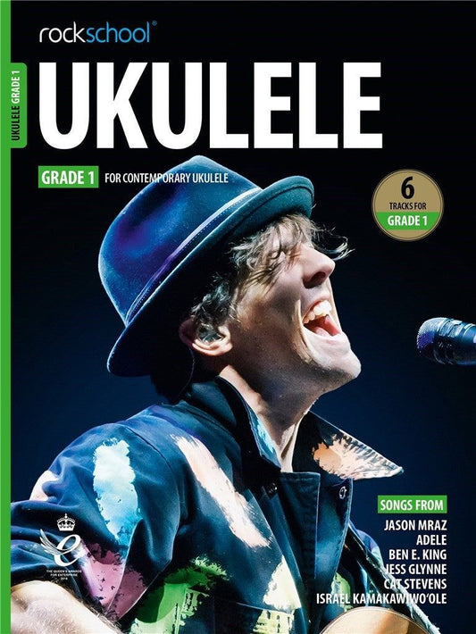 ROCKSCHOOL UKULELE GRADE 1 book cover featuring musician performing, includes songs by Jason Mraz, Adele, and more.